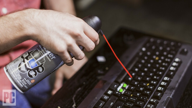 Canned air is used to clean out a keyboard