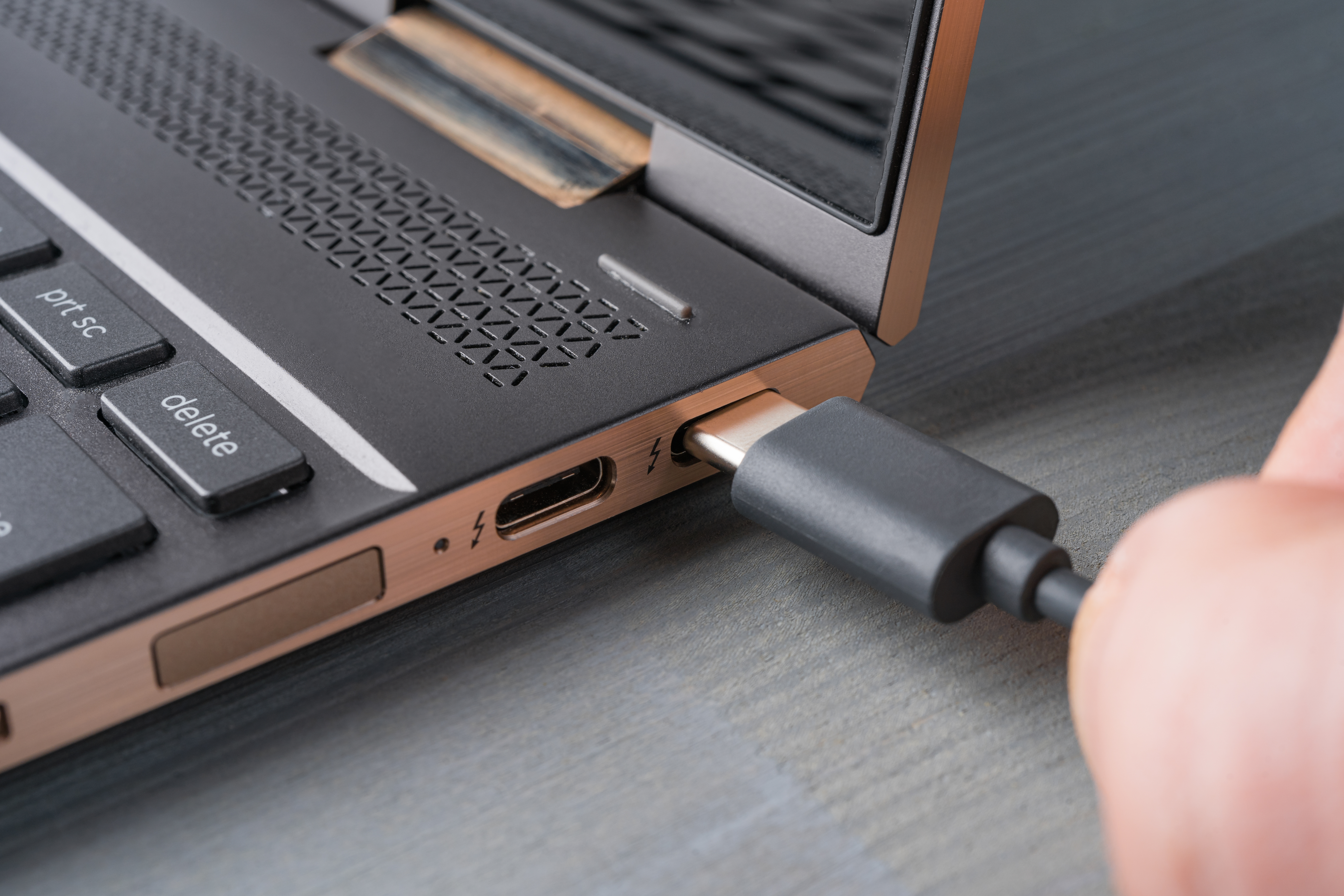 Plugging a USB-C cord into a laptop