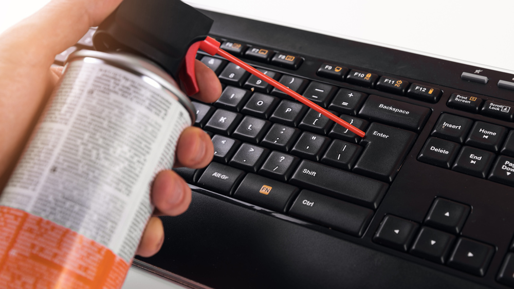 canned air aimed at a keyboard