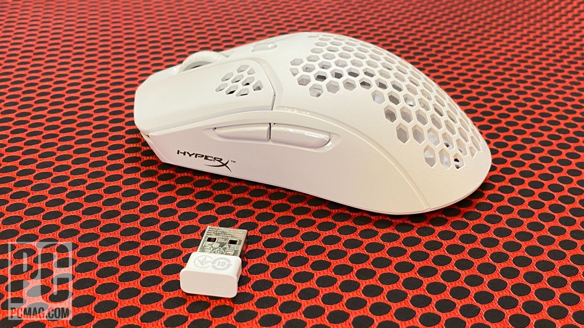 HyperX Pulsefire Haste wireless mouse side view with wireless dongle