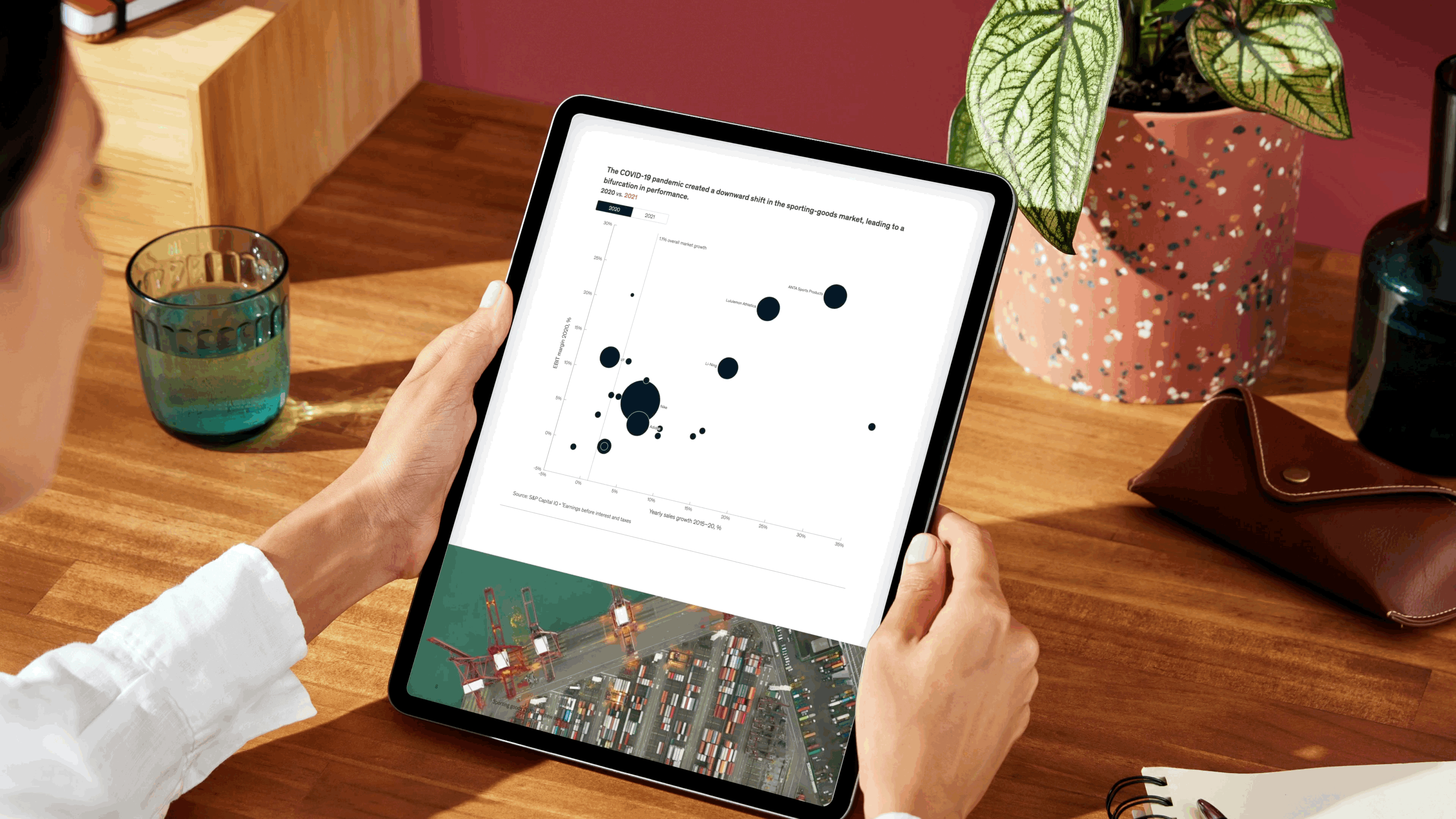 Two hands holding a tablet and viewing a Canva Doc file