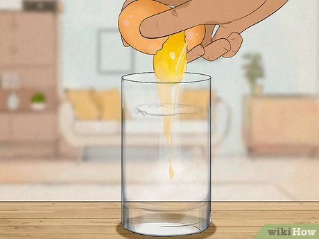 Step 6 Crack the egg into the glass of water.