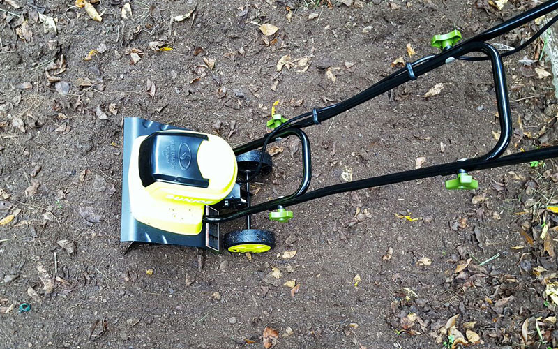Sun Joe tiller in garden bed